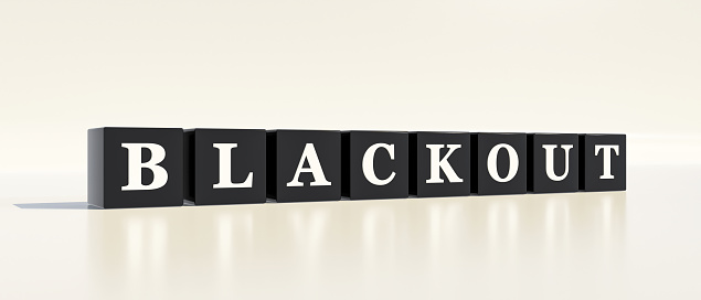 Black dices with white letters and the word blackout. Power cut, electricity, disruption, energy blackout, no power, energy crisis and faint.