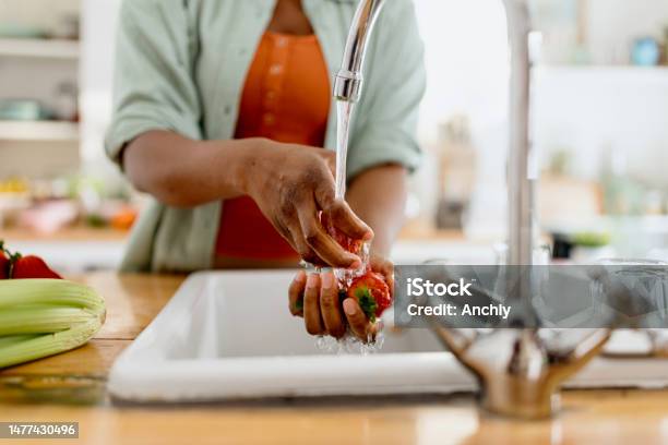 Close Up Of A Woman Washing Strawberries In The Kitchen Stock Photo - Download Image Now