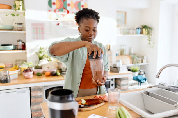 istock The woman is making a smoothie 1477430629