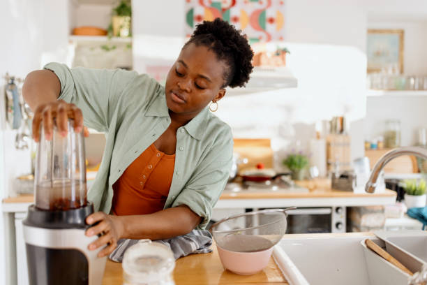 istock Woman making home made almond milk 1477430801