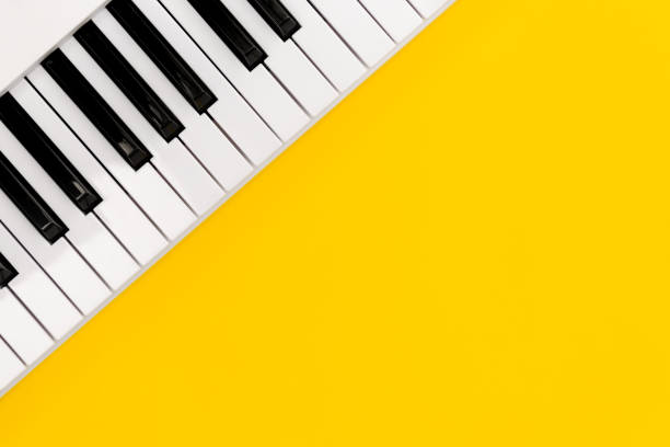 istock Piano keys on a yellow background, top view, flat lay. 1477432113