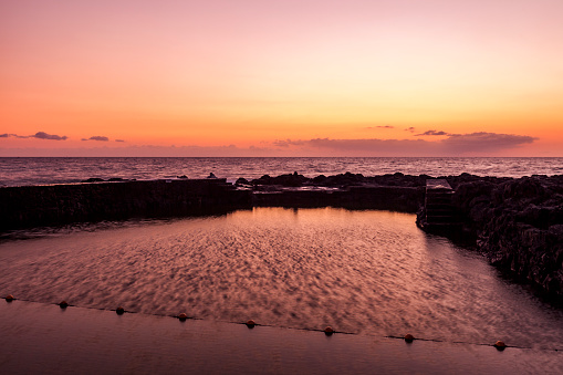 beautiful sunset and nature swimmingpool in reunion island, french overseas territory, france.