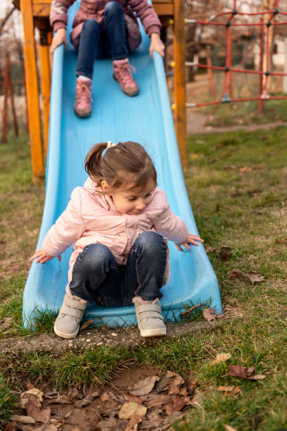 istock Children at the playground having fun while sliding 1477435323