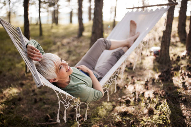 istock Happy senior woman enjoying in hammock. 1477435397