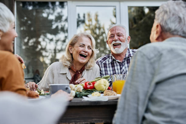 istock Cheerful mature friends talking during breakfast on a terrace. 1477437506