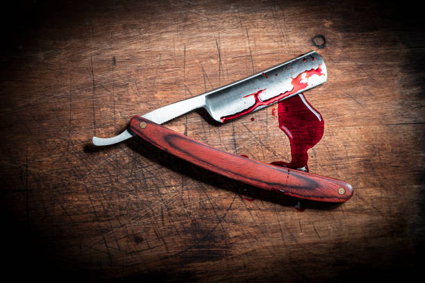 istock Bloody razor on wood 1477439337