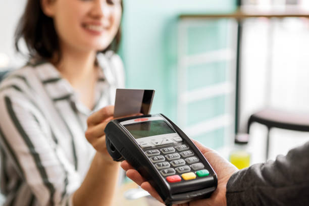 istock Woman making payment with credit card 1477439435