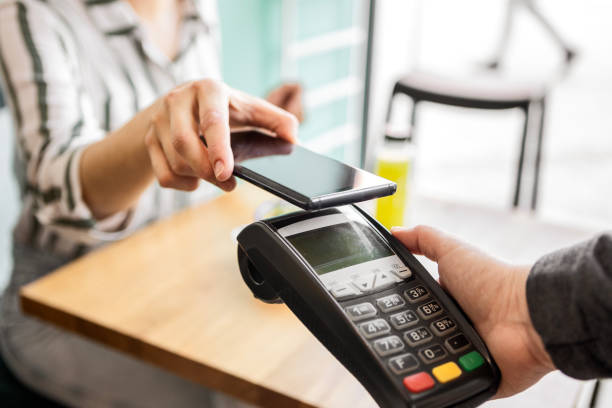 istock unrecognizable woman making payment with smart phone 1477439445