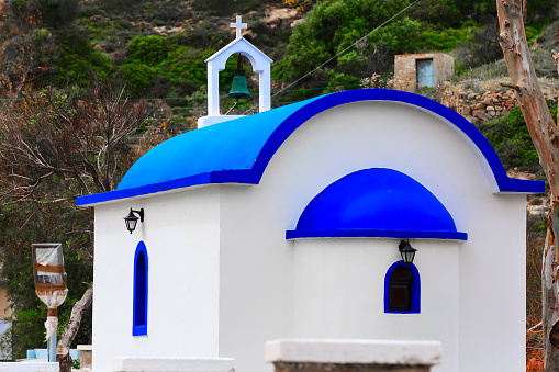 Blue dome architectural detail with Greek flags in a beautiful church in Santorini