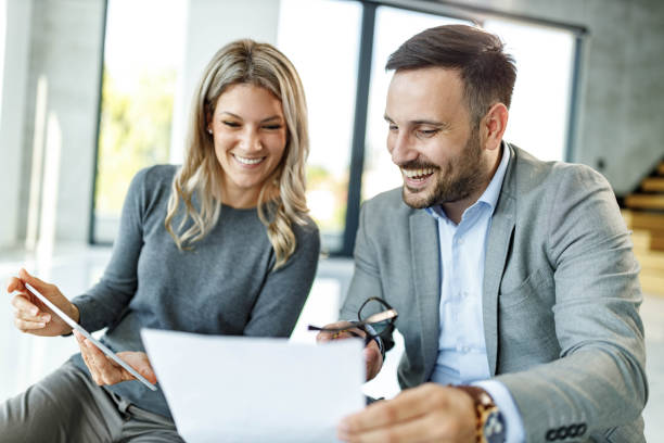 istock Happy business colleagues working on reports in casual office. 1477442832