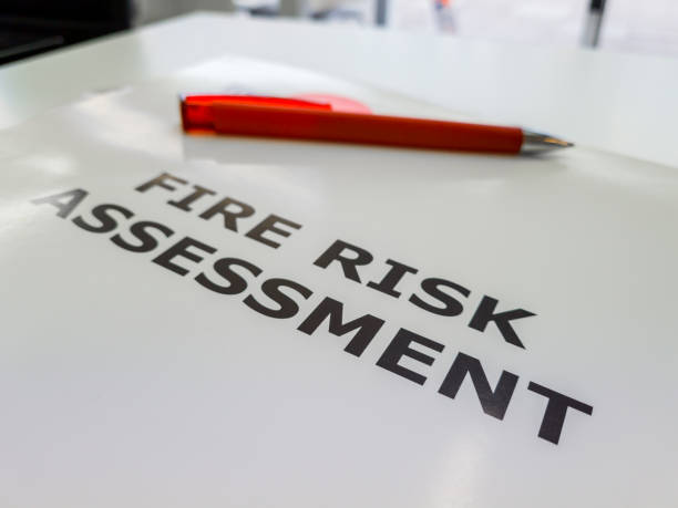 A file containing a Fire Risk Assessment. A file containing the Fire Risk Assessment, a legal requirement in the UK to assess and reduce the rise of fire for commercial properties, blocks of flats and workplaces. fire inspection stock pictures, royalty-free photos & images