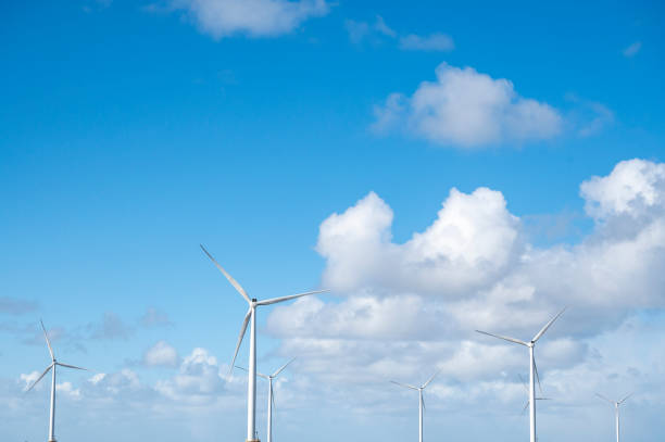 istock Wind turbines with blue sky and white clouds in the background 1477445754