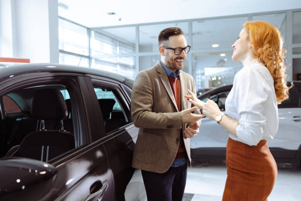 istock Couple visiting car dealership 1477447372
