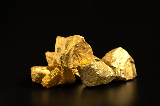 The pure gold ore found in the mine on black background