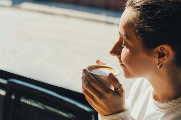 istock Beautiful woman enjoying a fragrant coffee in a cafe. 1477449859