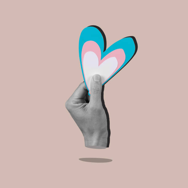 holding heart with the colors of transgender flag stock photo