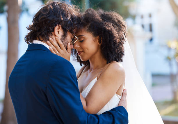 istock Wedding couple, hug and love outdoor for marriage celebration event together with commitment. Happy interracial man and woman at park with trust, partnership and support with hands on partner face 1477453593