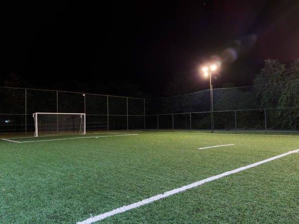 istock Soccer field with illumination and night sky 1477455903