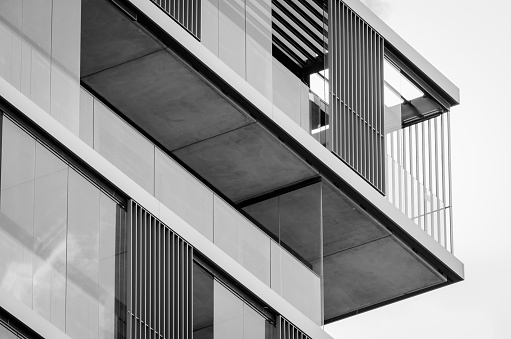 Close up of a modern building balcony made of glass, steel and geometric elements