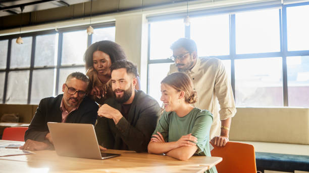 istock Diverse businesspeople sitting in an office and working on a laptop 1477456807