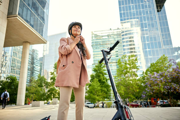 istock Commuter putting on safety helmet before ride home 1477459563