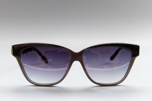 A pair of designer sun glasses isolated.