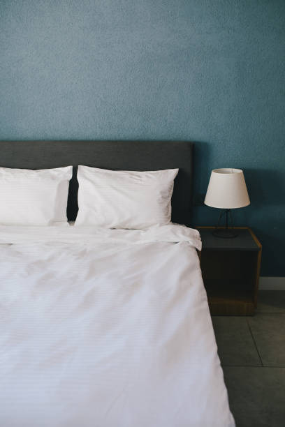 istock Bed and white linens in a hotel room. 1477460368