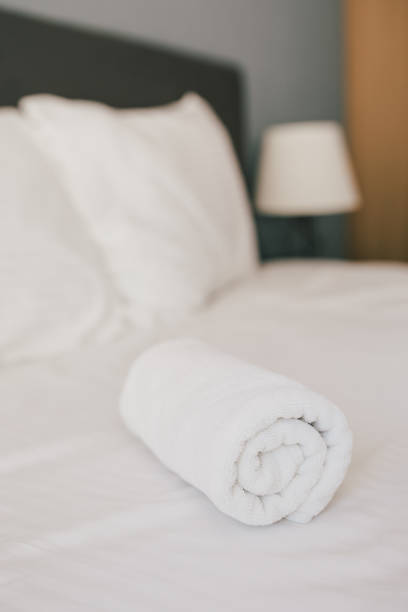 istock Bed and white linens in a hotel room. 1477460380