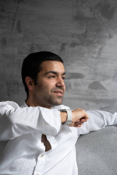 istock Hispanic young man sending voicemail on smart watch 1477460499