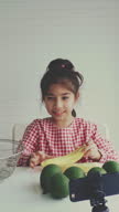 istock Little girl love with avocado 1477461119