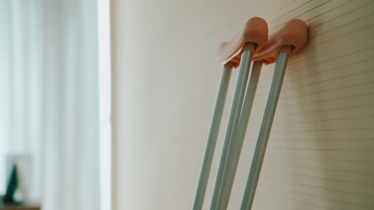 Walking Crutches Lying Against Wall in Hospital Patient Room.