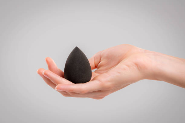 istock Hand with makeup sponges on white background 1477465433