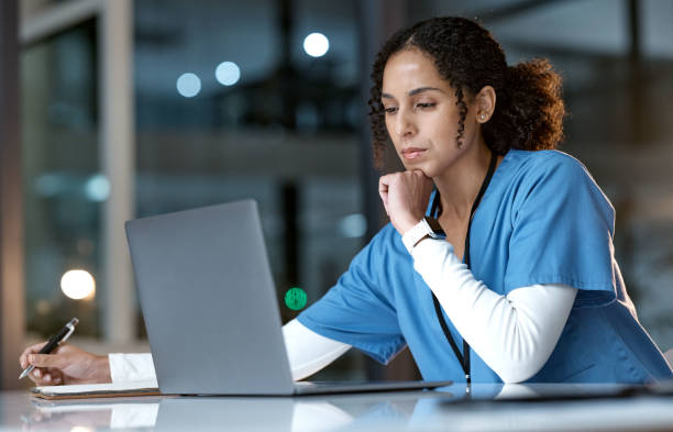 doctor, thinking and writing with laptop at night for healthcare solution, idea or planning at hospital. woman medical nurse working late in focus for research with notebook and computer at clinic - lärande bildbanksfoton och bilder