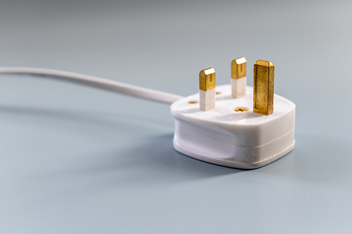 A three pin electric plug for electric appliances, system use in United Kingdom.