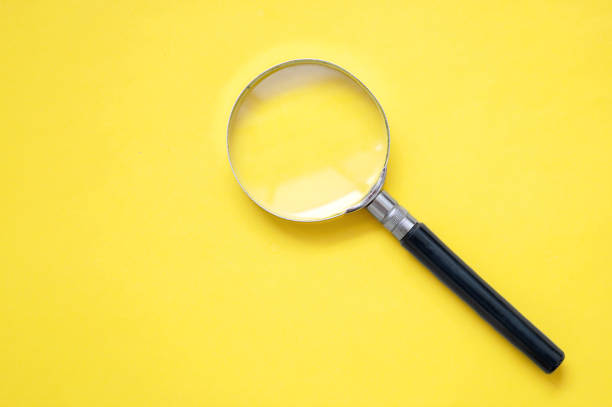 istock A yellow background with question marks and a magnifying glass 1477469497