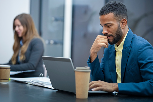 Businessman using laptop in office.