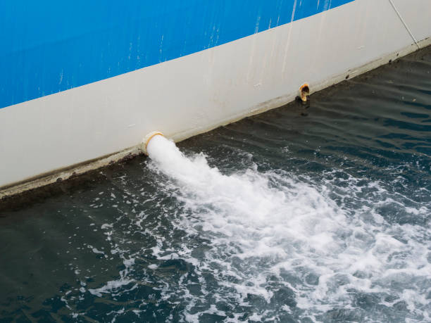 bilge water pumped out of the side of a ship bilge water pumped out of the side of a ship in the water of the port bilge of ship stock pictures, royalty-free photos & images