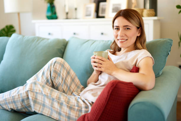 istock An attractive young woman relaxing at home drinking coffee 1477472956