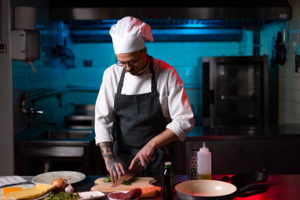 istock Professional chef cutting parsley in the kitchen. 1477474712