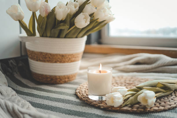 istock Burning candle and tulips in home interior 1477474817