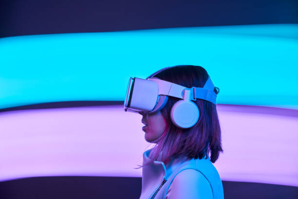 istock Woman is using virtual reality headset to access in metaverse. 1477475560