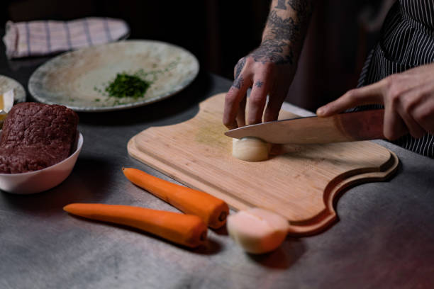 istock Cutting fresh onion in the kitchen! 1477475704