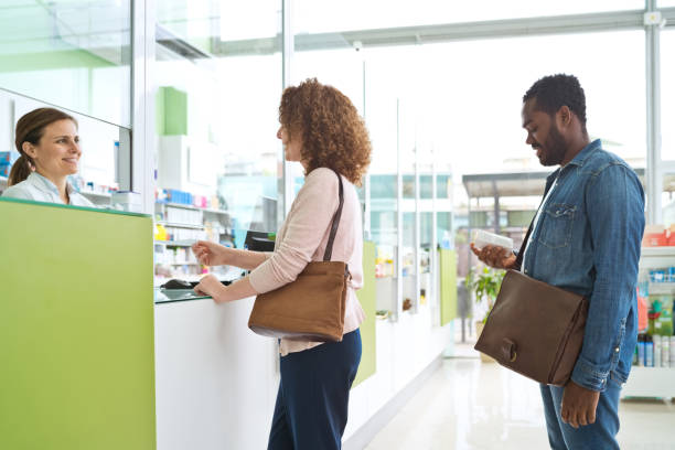 istock Customers standing in line in pharmacy 1477477310