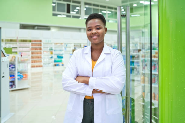 istock Female pharmacist standing next to door in pharmacy 1477479891