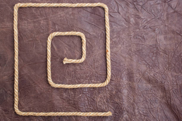easy maze made from jute rope on brown leather texture