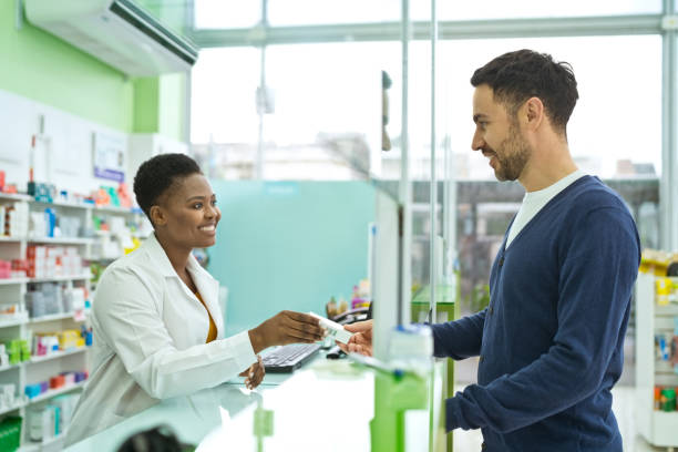 istock Female pharmacist talking with male customer 1477480328