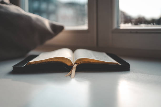 istock Open bible on windowsill, city view, morning prayer 1477482219