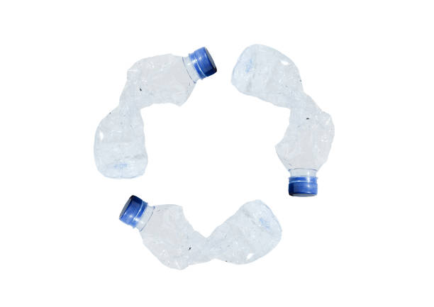 istock Crumpled plastic bottles form a recycle sign. 1477483163