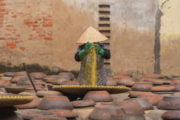 istock A worker working with heap of old ceramic or clay mud sauce pottery jars, vase or pots pattern texture background in garden. Terracotta. People lifestyle. 1477483634