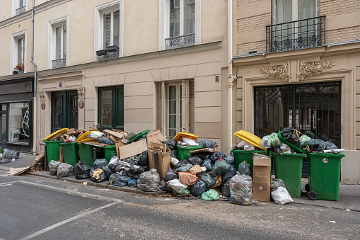 Paris, France - 03 28 2023: Garbage cans left on the public highway, following the garbage collectors' strike
